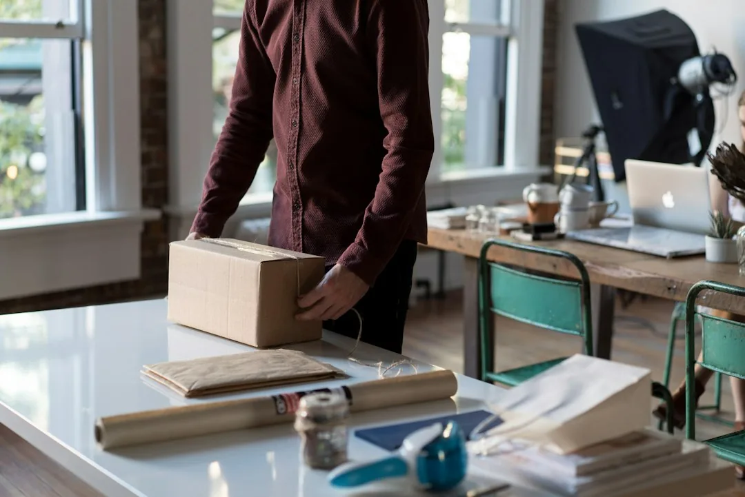Mover wrapping dishes in packing paper