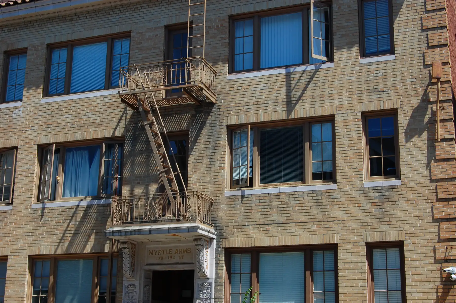 Brick apartment building with fire escapes in Oakland, California