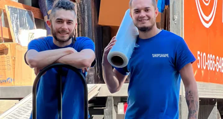 Local movers unloading boxes and furniture at a customer's home